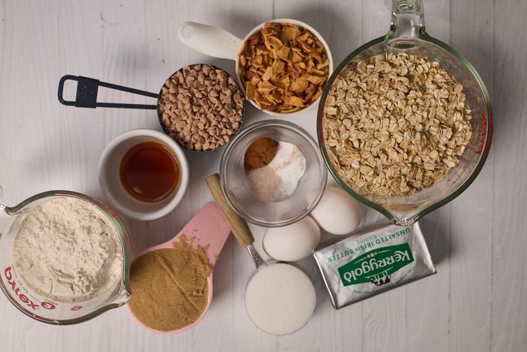 Oats, dehydrated apples, cinnamon chips, flour, butter, eggs, and sugars for oatmeal apple cinnamon cookies.