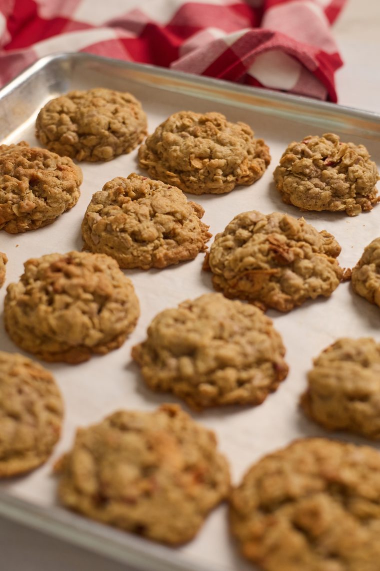 Oatmeal apple cinnamon cookies on a parchment-lined baking sheet.