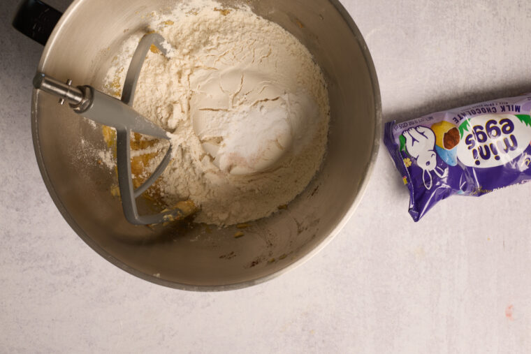 Stand mixer with flour and sugar mixing, next to Mini Eggs candy—ready to make browned butter Cadbury Egg blondies.