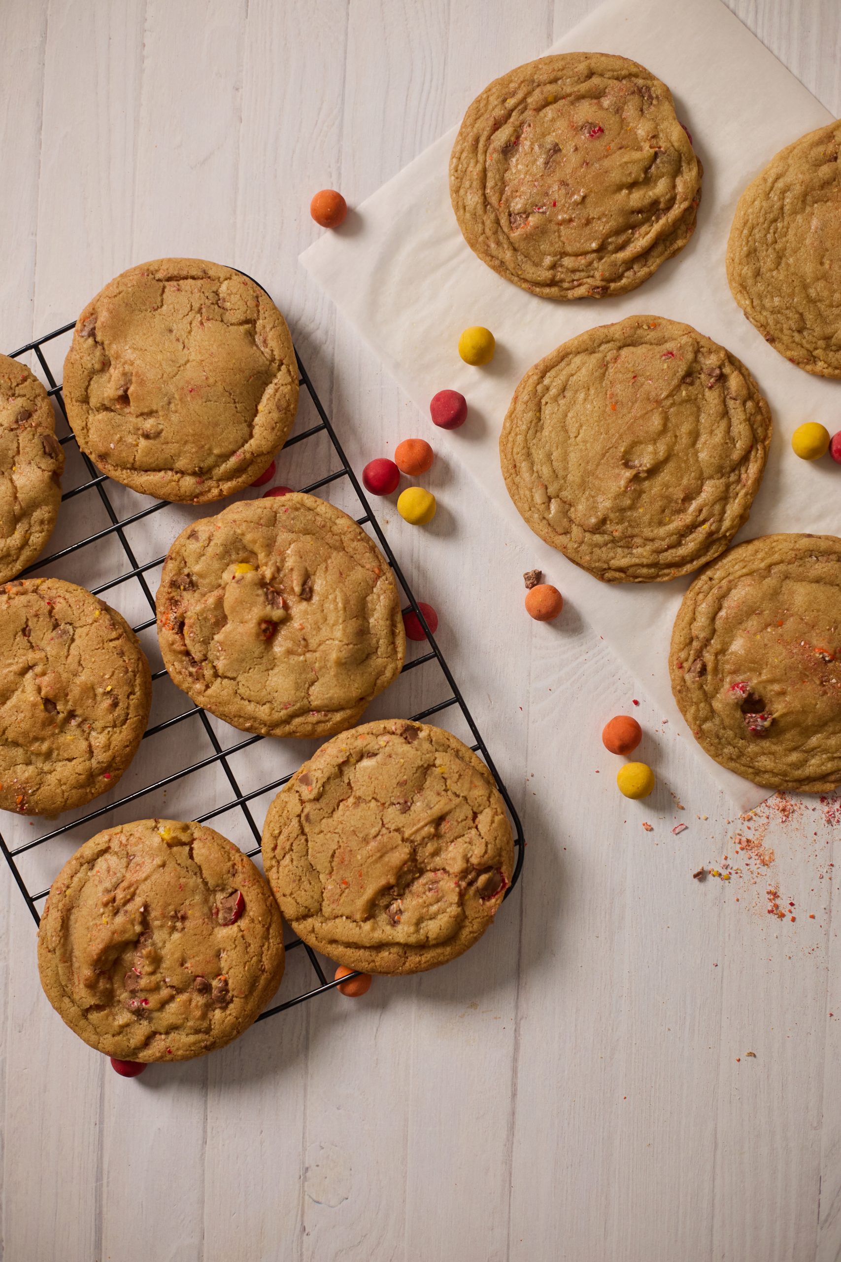 Golden Cadbury egg cookies on a cooling rack and light countertop.