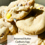 Chunky, gooey cookies loaded with Cadbury Egg bits pile up on a plate. Text says: Browned Butter Cadbury Egg Cookies Mrs Madi.