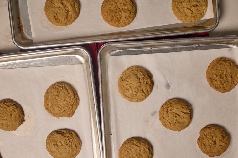 freshly baked maple brown sugar cookies on a cookie sheet lined with parchment paper