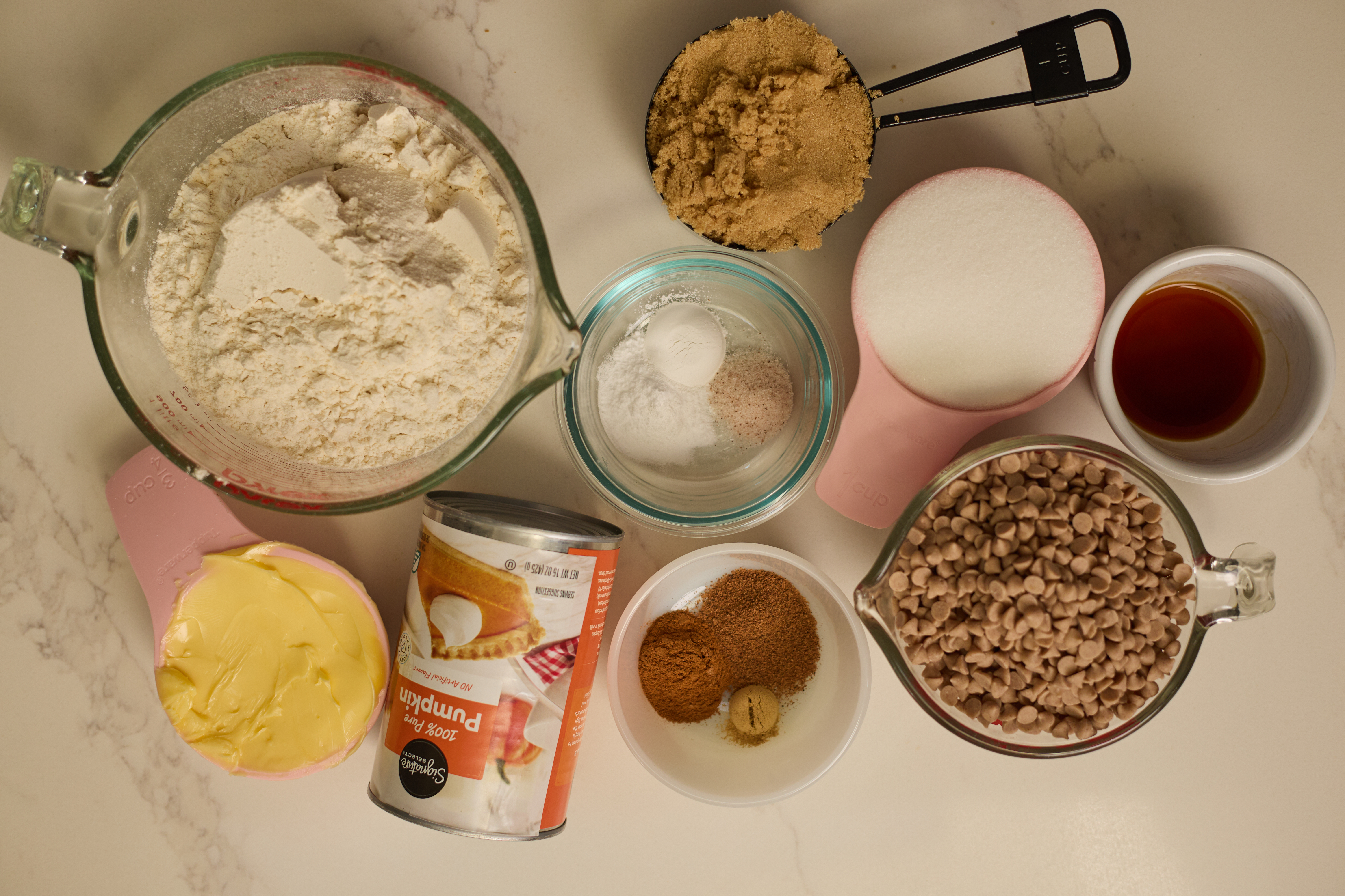 Pumpkin puree, cinnamon chips, flour, butter, sugars, and spices for pumpkin bars.