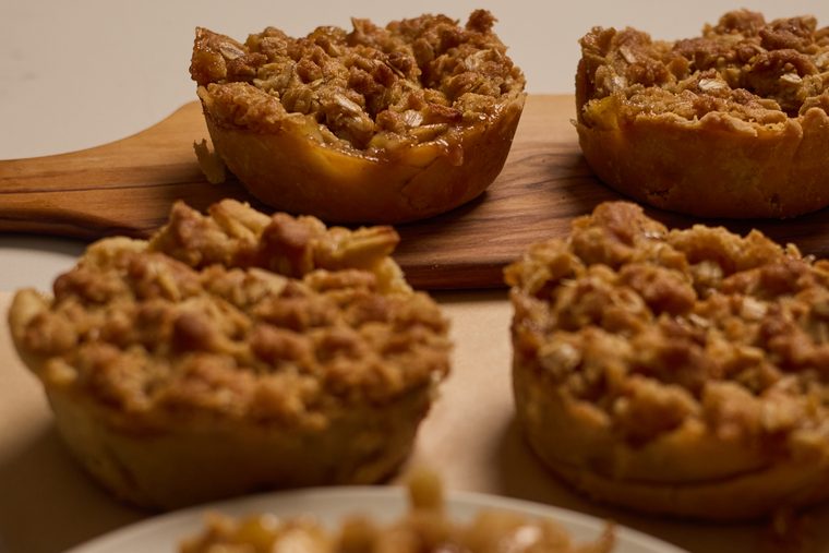 mini dutch apple pies on a wooden board