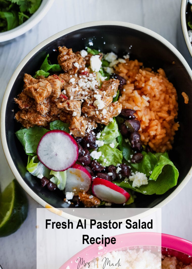 A bowl loaded with al pastor-seasoned meat, Mexican rice, black beans, lettuce, radish slices, and crumbled cheese. Surrounded by lime and other tasty sides. Text says: “Fresh Al Pastor Salad Recipe—dig into this vibrant salad!”.