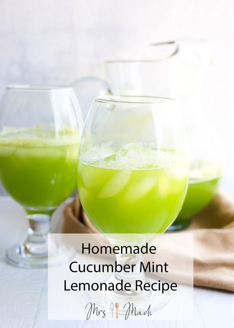 Three glasses of cool cucumber mint lemonade with ice sit on a white table, pitcher in the back, beige cloth peeking in. Text says: Homemade Cucumber Mint Lemonade Recipe.