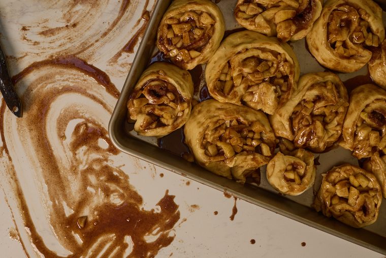 raw apple pie cinnamon rolls in a deep pan
