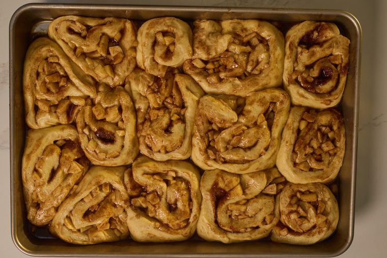 risen apple pie cinnamon rolls in a deep pan