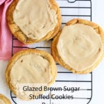 Three big, shiny-glazed brown sugar cookies cool on a black rack. Pink cloth nearby. Text: Glazed Brown Sugar Stuffed Cookies Recipe.