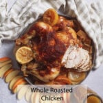 Juicy roasted chicken with lemon, apple, and onion on a light cloth. Text: Whole Roasted Chicken w Apple, Onion & Herbs.