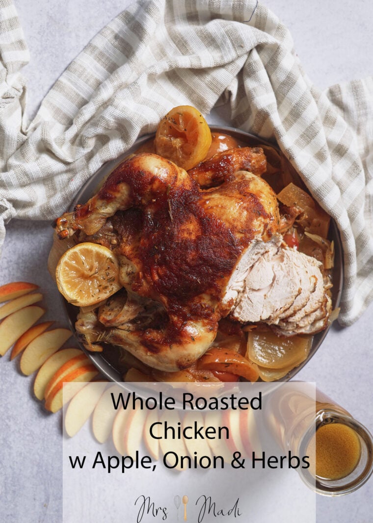 Juicy roasted chicken with lemon, apple, and onion on a light cloth. Text: Whole Roasted Chicken w Apple, Onion & Herbs.