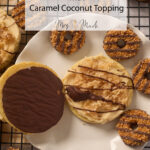 Big samoa sugar cookies with caramel, coconut, and chocolate drizzle on a plate, with mini ones around them on a cooling rack.