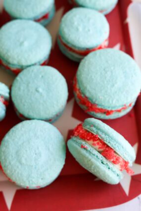 Blue rocket pop macarons with red and white filling on a red tray with white stars&mdash;festive and fun!.