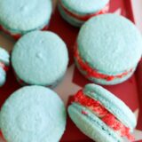 Blue rocket pop macarons with red and white filling on a red tray with white stars&mdash;festive and fun!.