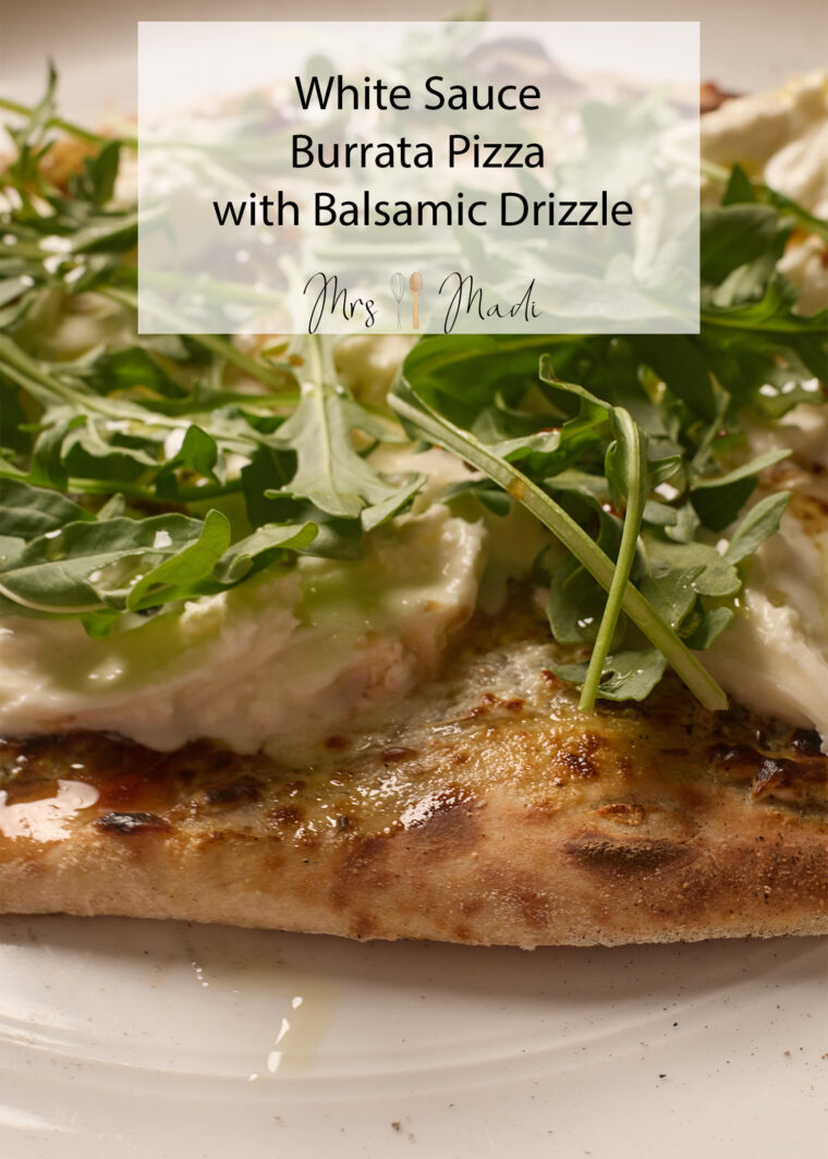 Zoomed-in shot of burrata pizza with creamy sauce, arugula, and balsamic drizzle. Text says: &ldquo;White Sauce Burrata Pizza.&rdquo;.