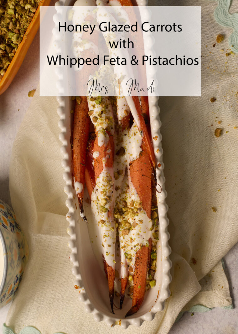Honey glazed carrots with whipped feta and pistachios in a rectangular dish. Text overlay shares deets about the dish.