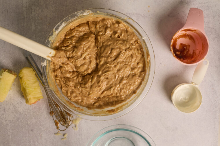 Grated apples folded into thick spiced cake batter.