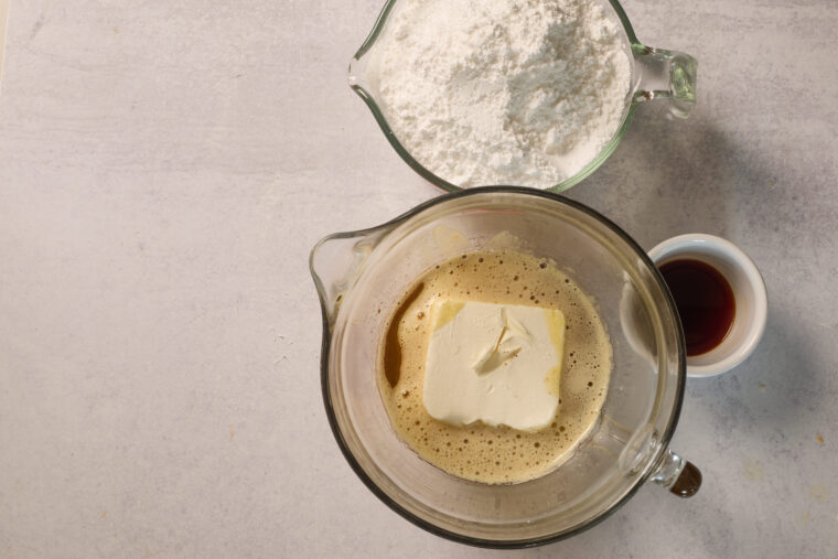 Browned butter and cream cheese combined in a bowl to make frosting.