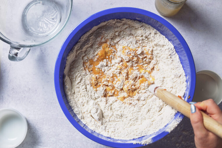 mixing pumpkin cinnamon roll dough