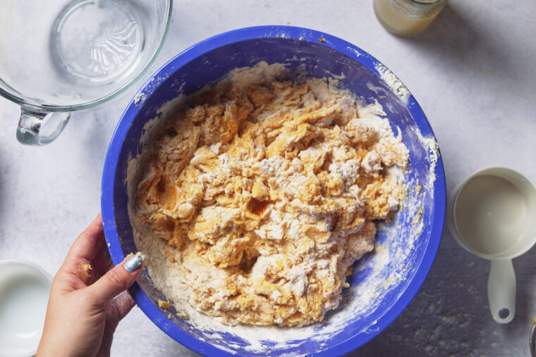 mixing pumpkin cinnamon roll dough