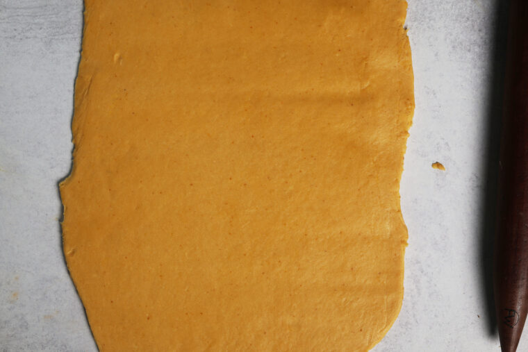 rolled out pumpkin cinnamon roll dough